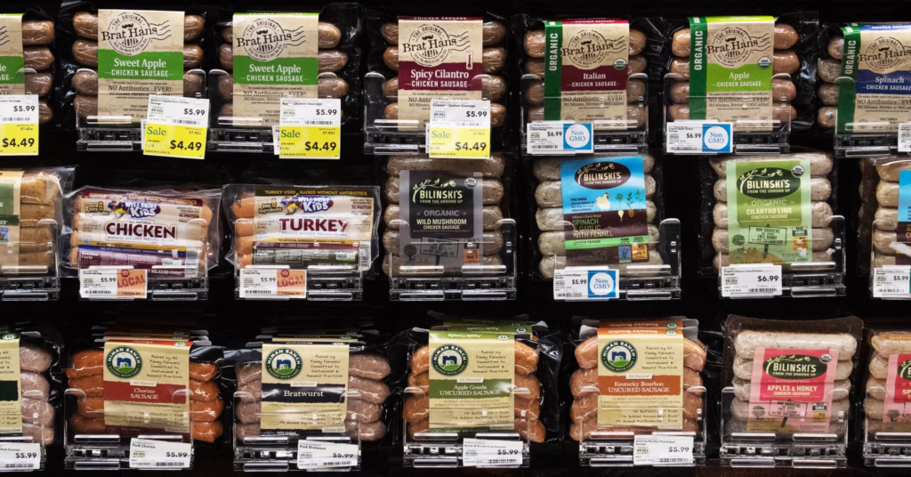 grillable meats in pusher trays at a grocery store