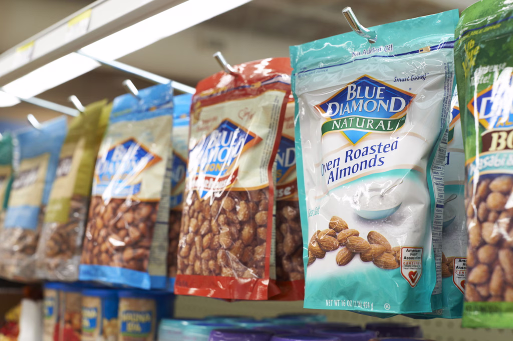 bags of snacking almonds hanging from pegs